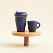 Two coffee cups on a small table.