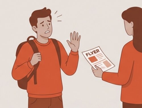 Student declining a flyer on campus